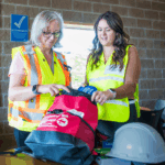 Two staff members assembling an emergency kit